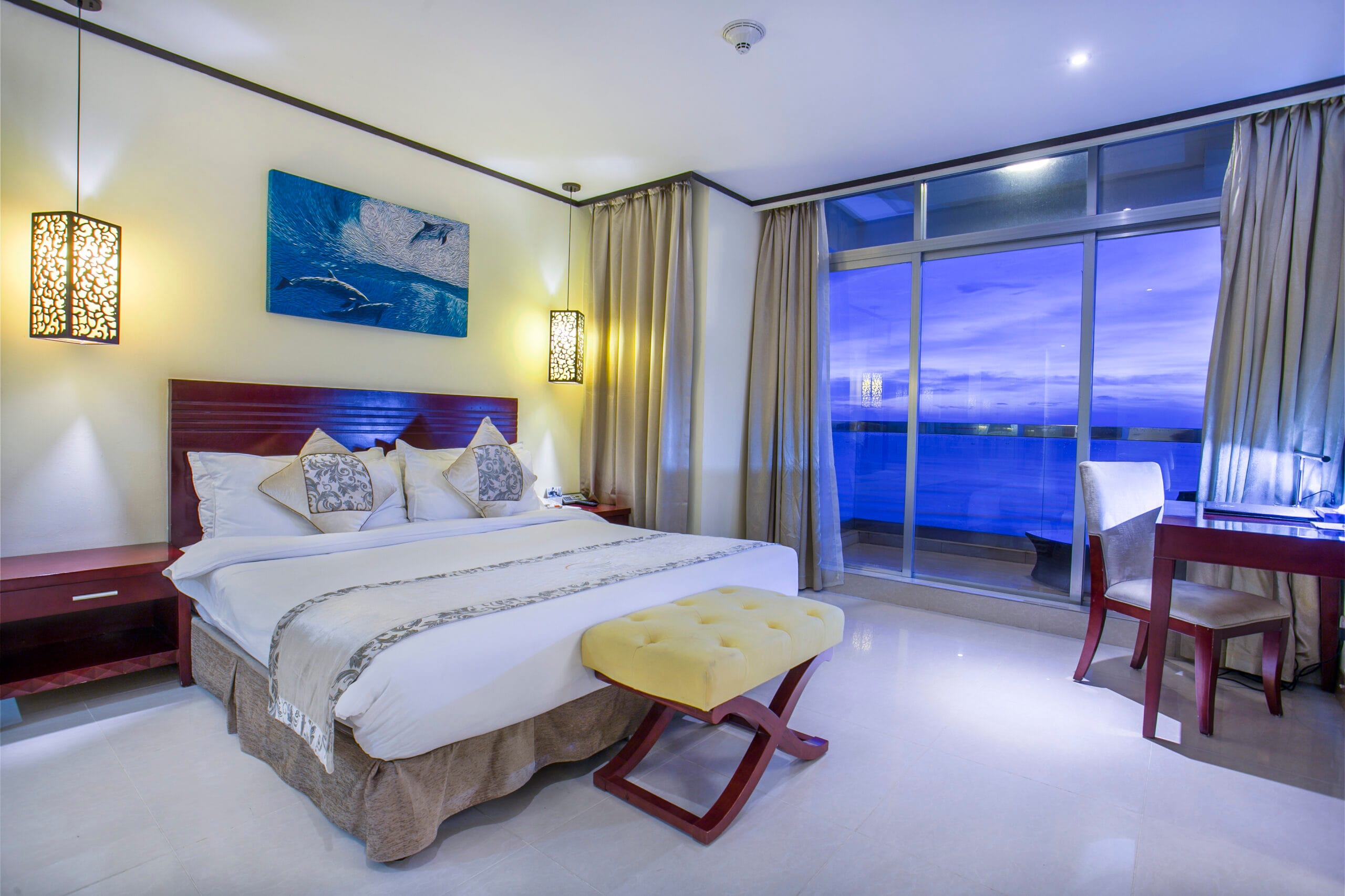 Each room features a private balcony, allowing guests to unwind while soaking in the picturesque surroundings.